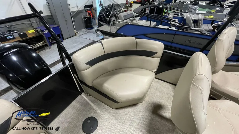 Slide: The Image of 2020 Berkshire STS Entertainment 25 boat interior with beige seating in showroom. - 5