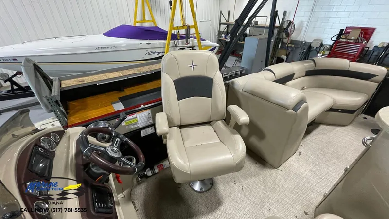 Slide: The Image of 2020 Berkshire STS Entertainment 25 boat interior with beige seating and steering console. - 7