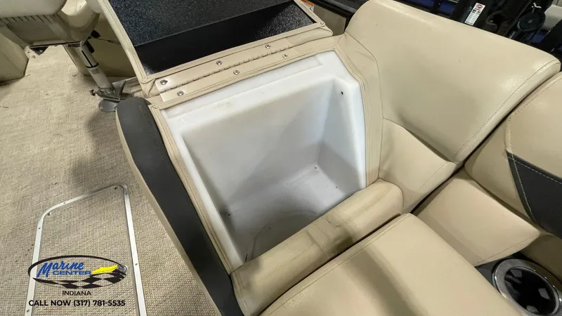 Slide: The Image of Open storage compartment in a 2020 Berkshire STS Entertainment 25 boat with beige seating. - 9