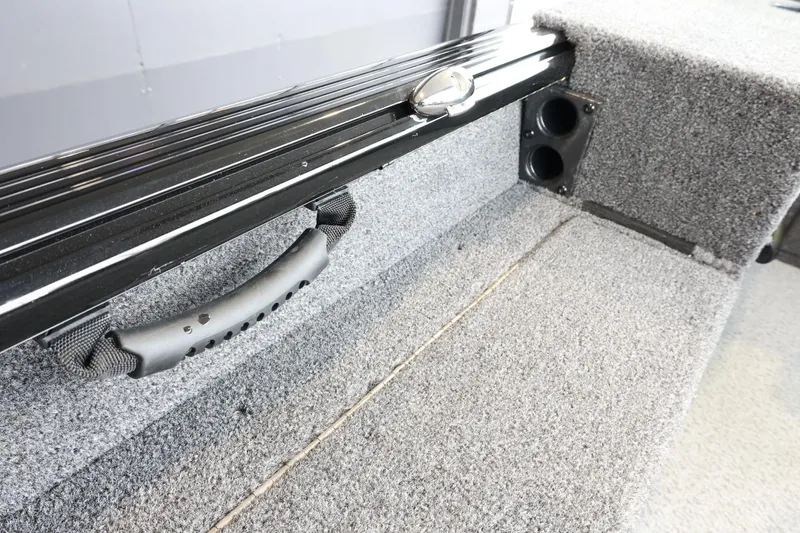 Slide: The Image of 2025 Lund 1875 Impact XS Sport interior with carpeted storage and handle. - 14