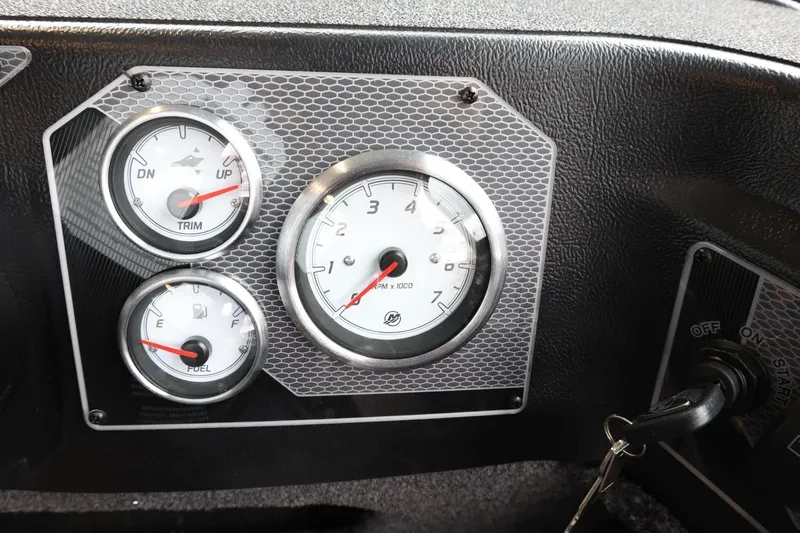Slide: The Image of Dashboard of 2025 Lund 1875 Impact XS Sport boat with gauges and ignition key. - 21