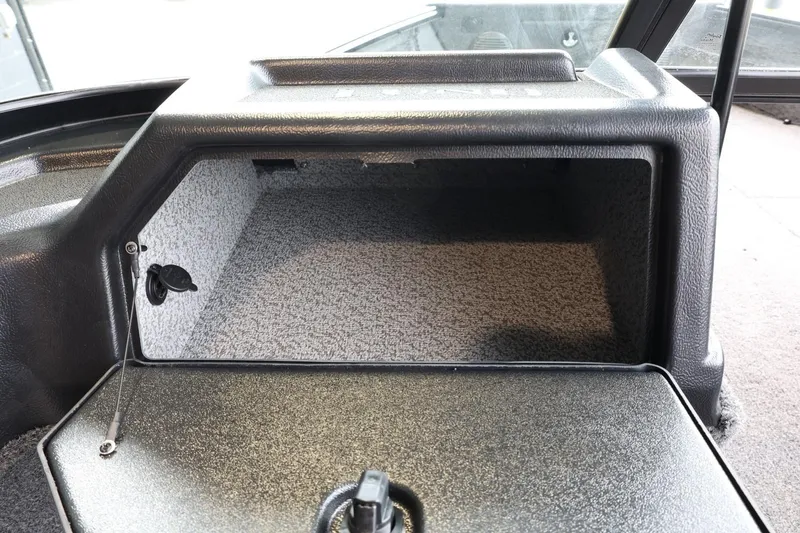 Slide: The Image of 2025 Lund 1875 Impact XS Sport boat storage compartment, open and empty. - 22