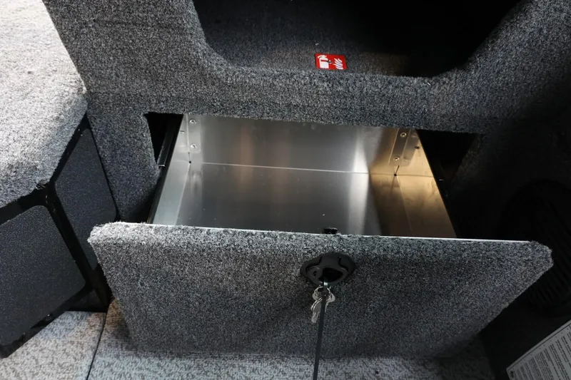 Slide: The Image of Open storage compartment in 2025 Lund 1875 Impact XS Sport boat interior. - 24