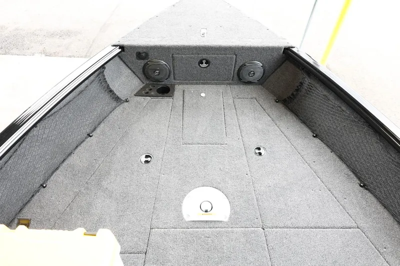 Slide: The Image of 2025 Lund 1875 Impact XS Sport boat interior with carpeted deck and storage compartments. - 26