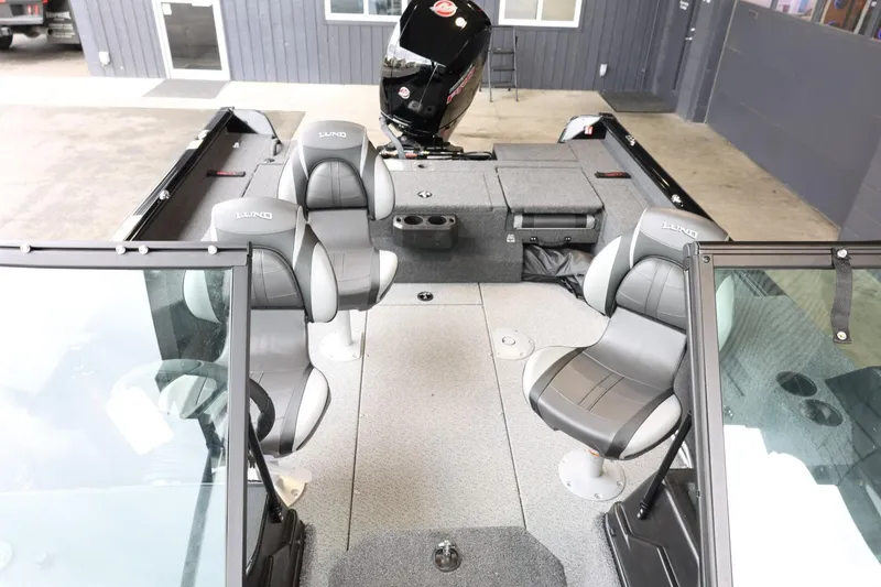 Slide: The Image of 2025 Lund 1875 Impact XS Sport boat interior with seating and motor. - 27