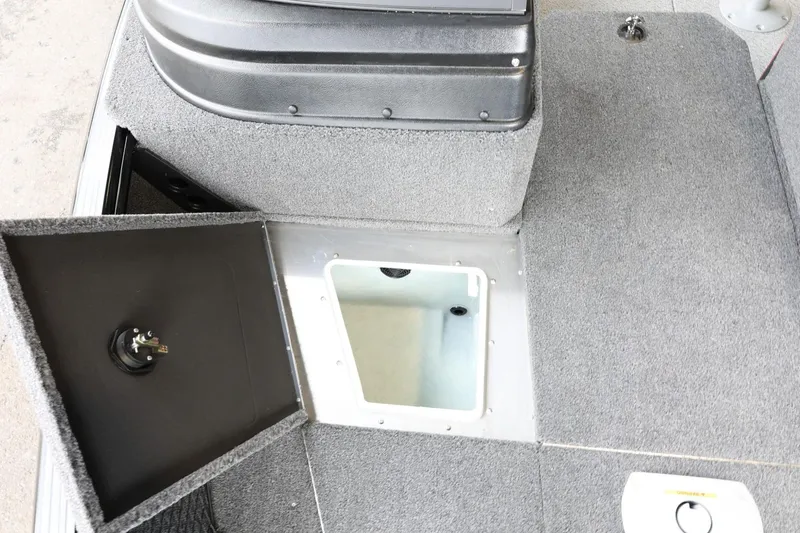 Slide: The Image of 2025 Lund 1875 Impact XS Sport boat interior storage compartment, open hatch view. - 28