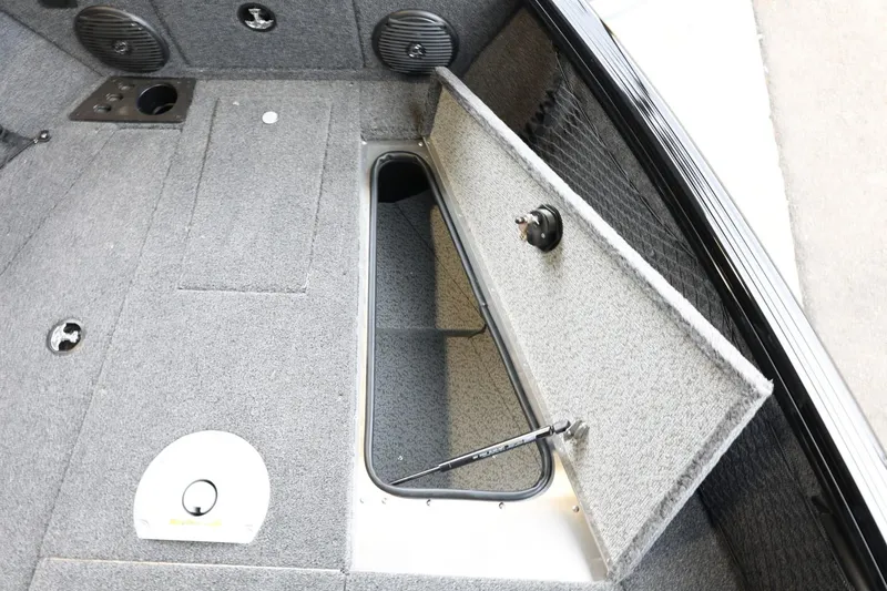 Slide: The Image of 2025 Lund 1875 Impact XS Sport boat interior with open storage compartment. - 29