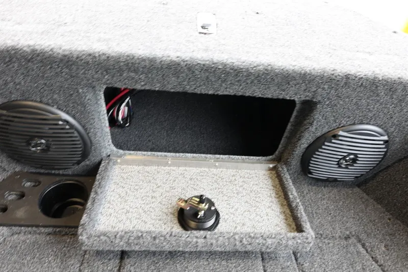 Slide: The Image of 2025 Lund 1875 Impact XS Sport boat interior with speakers and storage compartment. - 32