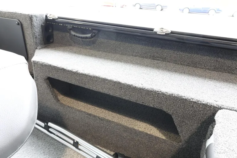 Slide: The Image of Interior view of 2025 Lund 1875 Impact XS Sport boat, featuring storage compartment. - 34