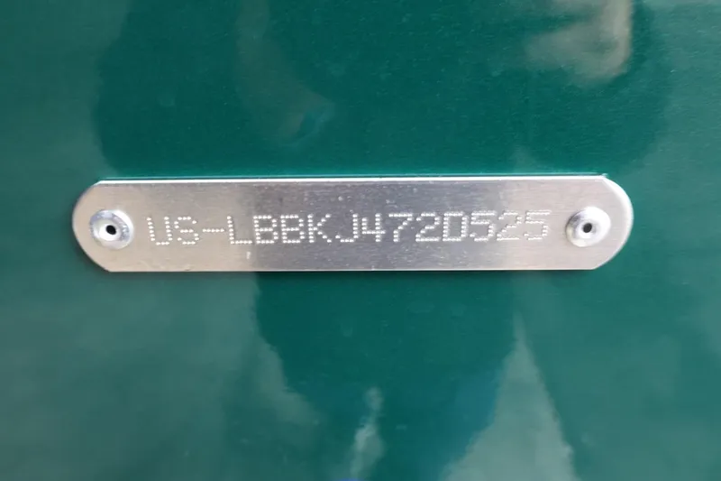 Slide: The Image of 2025 Lund 1875 Impact XS Sport identification plate on green surface. - 36