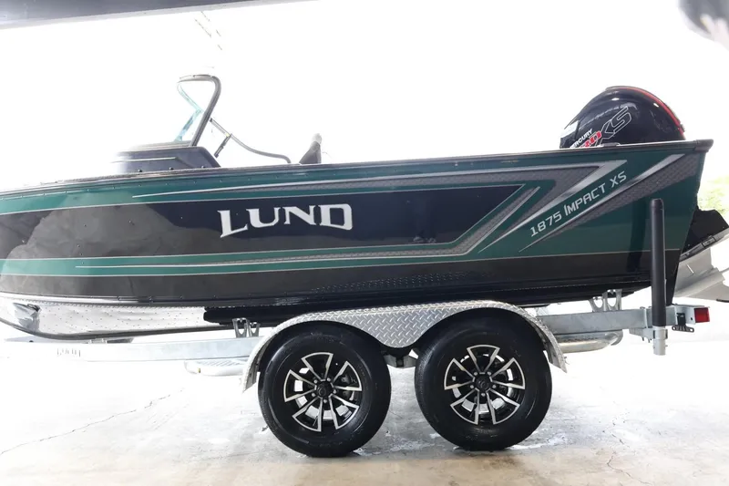 Slide: The Image of 2025 Lund 1875 Impact XS Sport boat on trailer, side view. - 5