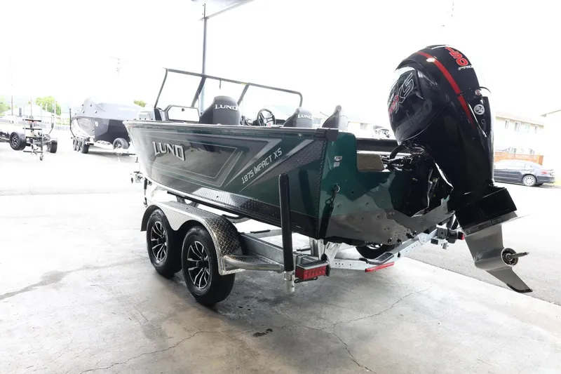 Slide: The Image of 2025 Lund 1875 Impact XS Sport boat on trailer, rear view with outboard motor. - 6
