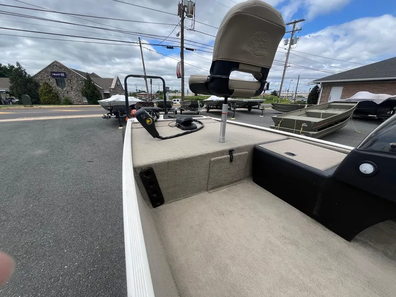 Slide: The Image of 2022 Tracker Bass Tracker Classic XL boat on display in a parking lot. - 12
