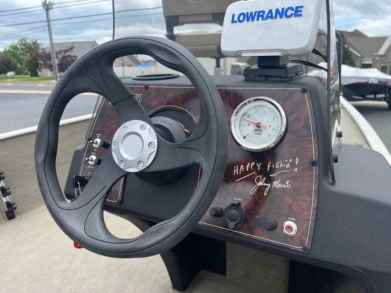 Slide: The Image of 2022 Tracker Bass Tracker Classic XL dashboard with steering wheel and Lowrance fish finder. - 8