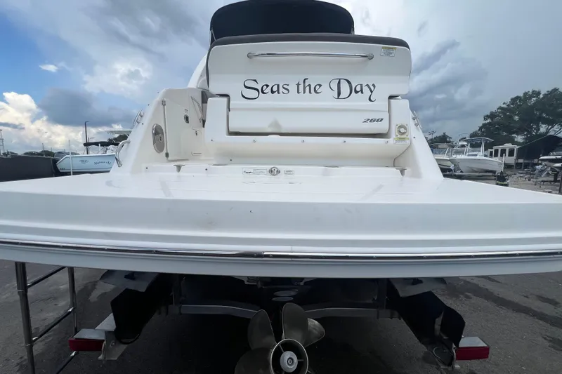 Slide: The Image of 2014 Sea Ray 260 Sundancer cockpit with steering wheel, control panel, and sink area. - 12