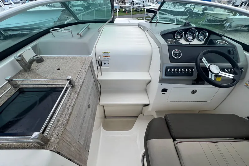 Slide: The Image of 2014 Sea Ray 260 Sundancer cockpit with dashboard and seating area. - 17