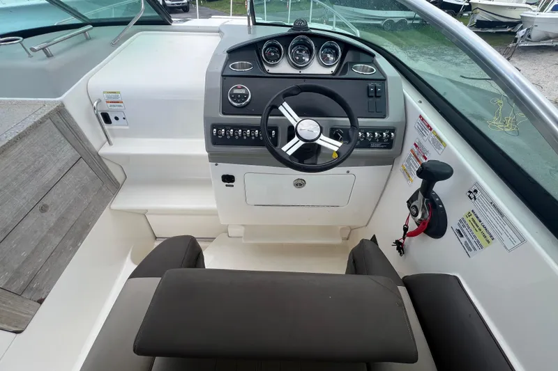 Slide: The Image of 2014 Sea Ray 260 Sundancer boat deck with open hatch and sleek design. - 18