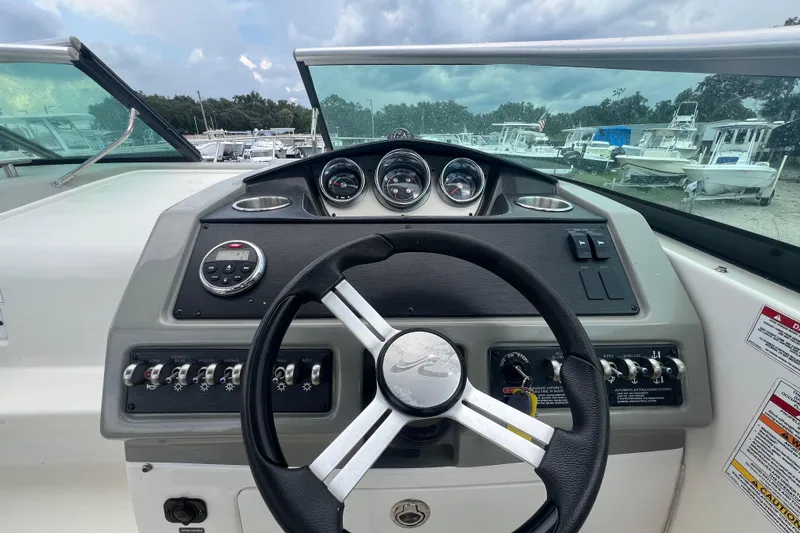 Slide: The Image of 2014 Sea Ray 260 Sundancer boat, top view, docked on pavement. - 19