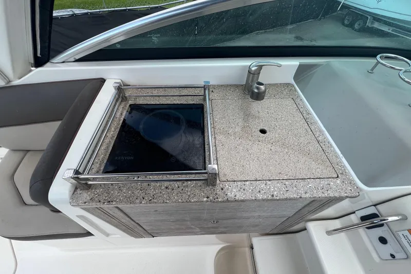 Slide: The Image of 2014 Sea Ray 260 Sundancer boat interior with seating and helm, viewed from above. - 20