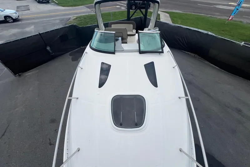 Slide: The Image of Interior of 2014 Sea Ray 260 Sundancer with wooden table and door. - 24