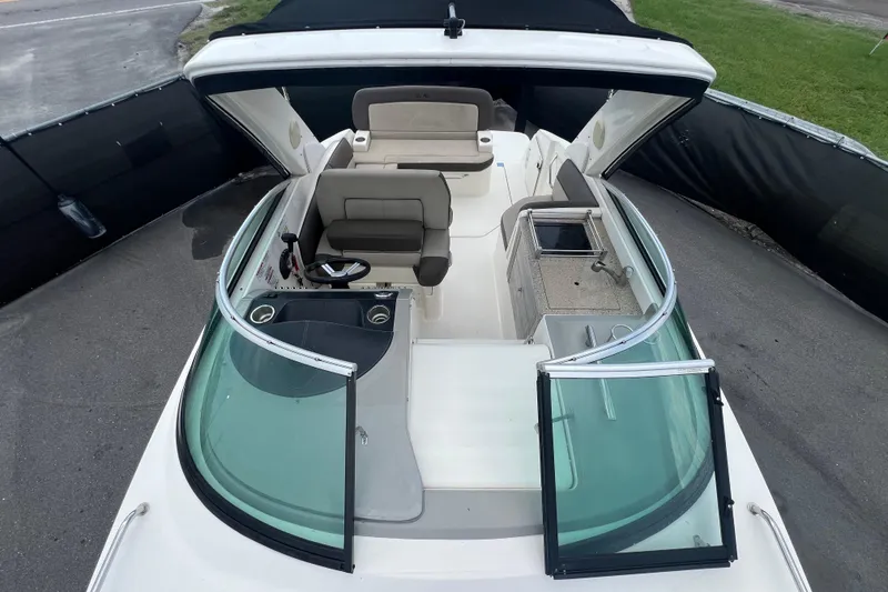 Slide: The Image of 2014 Sea Ray 260 Sundancer bathroom with sink, toilet, and porthole window. - 25