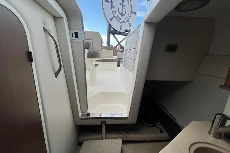 Slide: The Image of Engine compartment of a 2014 Sea Ray 260 Sundancer boat, featuring a MerCruiser engine. - 34