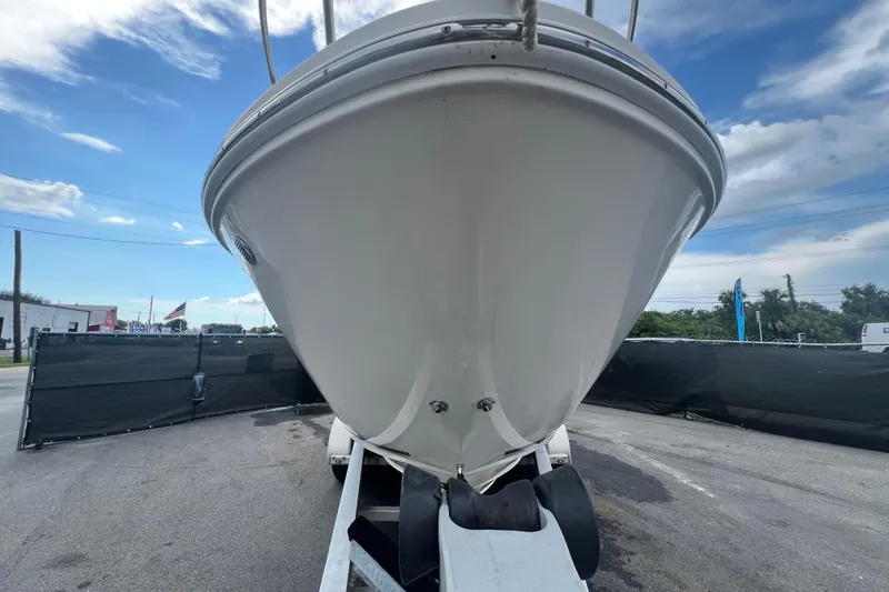 Slide: The Image of 2014 Sea Ray Sundancer 260 boat on trailer, displayed outdoors under clear sky. - 6