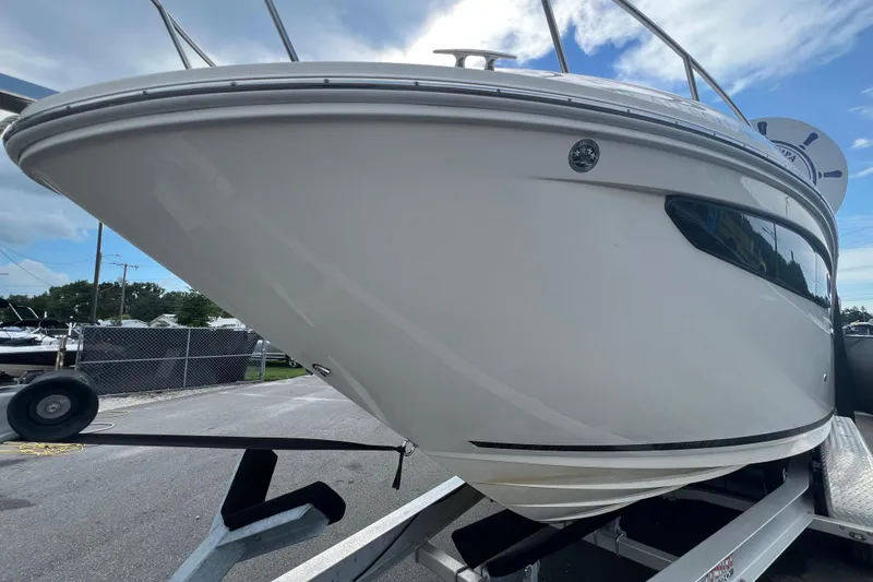 Slide: The Image of 2014 Sea Ray Sundancer 260 boat on trailer, parked outdoors under clear sky. - 7