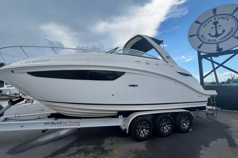 Slide: The Image of 2014 Sea Ray Sundancer 260 boat on trailer, sunlit street view. - 9