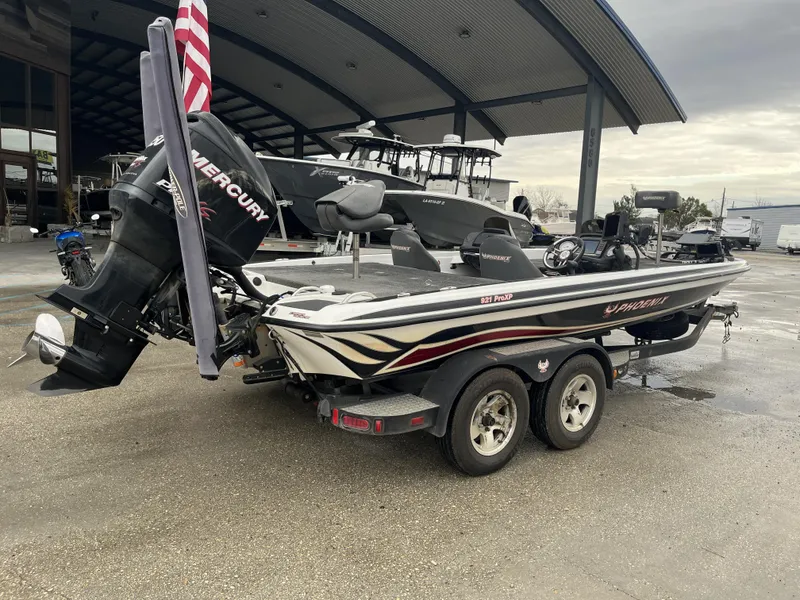 Slide: The Image of 2012 Phoenix 921 PRO XP boat with Mercury engine on trailer, parked outdoors. - 12