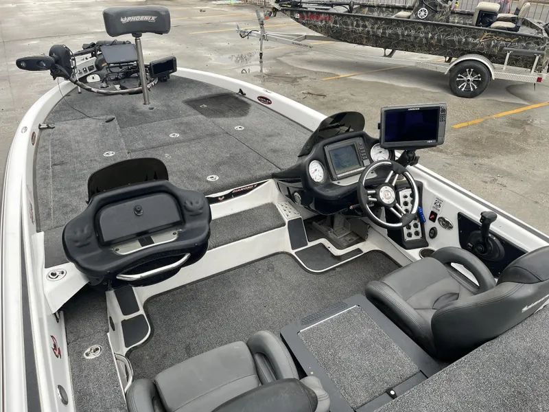 Slide: The Image of 2012 Phoenix 921 PRO XP boat interior with advanced navigation equipment and seating. - 14