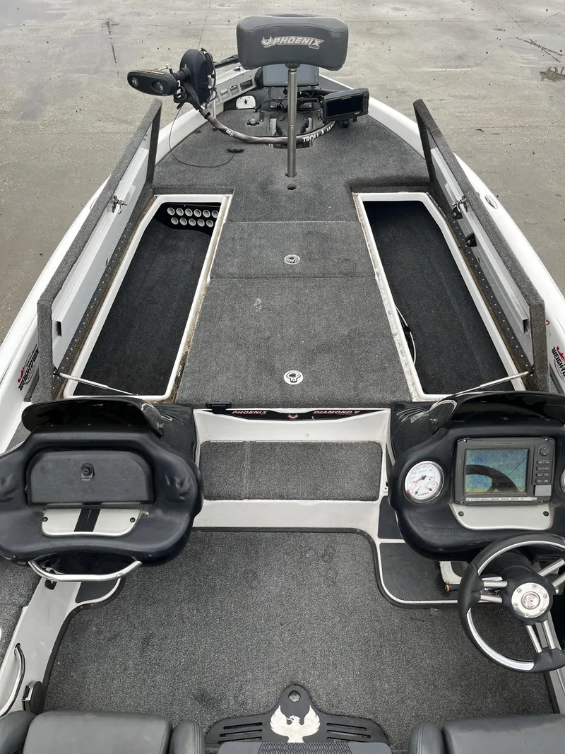 Slide: The Image of 2012 Phoenix 921 PRO XP boat interior with steering wheel and navigation equipment. - 15