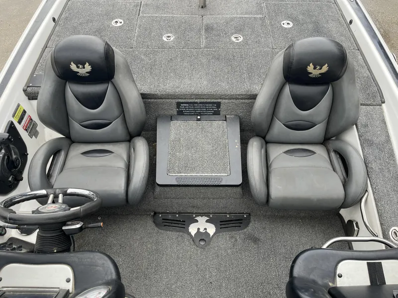 Slide: The Image of 2012 Phoenix 921 PRO XP boat interior with two gray seats and steering wheel. - 19