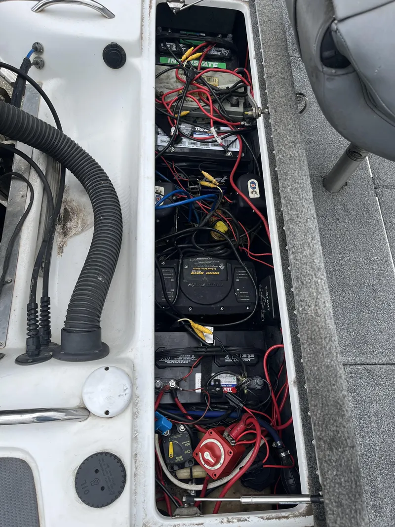 Slide: The Image of 2012 Phoenix 921 PRO XP boat battery compartment with wiring and components. - 21