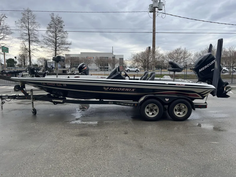 Slide: The Image of 2012 Phoenix 921 PRO XP boat on trailer, parked outdoors on a cloudy day. - 5