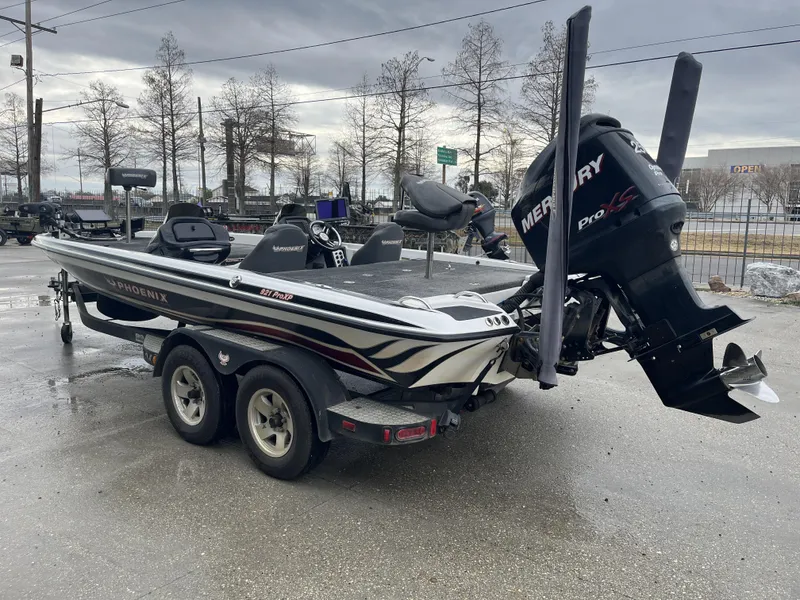 Slide: The Image of 2012 Phoenix 921 PRO XP boat with Mercury engine on trailer, parked outdoors. - 6