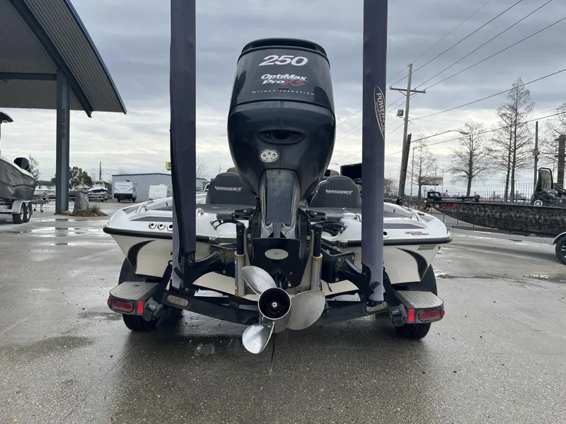 Slide: The Image of 2012 Phoenix 921 PRO XP boat with powerful outboard motor, parked outdoors. - 7