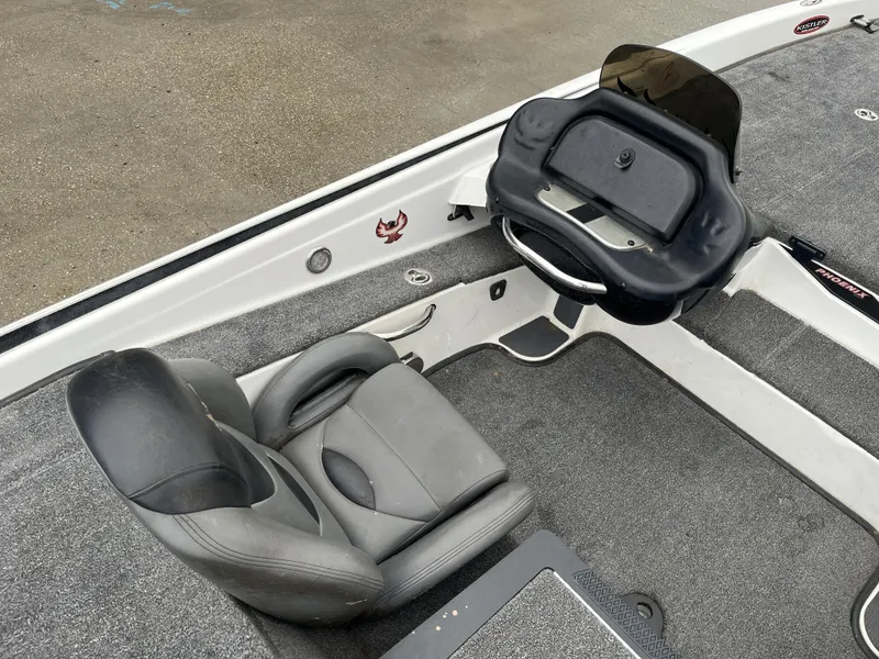 Slide: The Image of 2012 Phoenix 921 PRO XP boat interior with gray seating and steering console. - 9