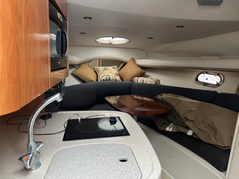 Slide: The Image of 2004 Four Winns 248 Vista cabin interior with kitchenette and seating area. - 19