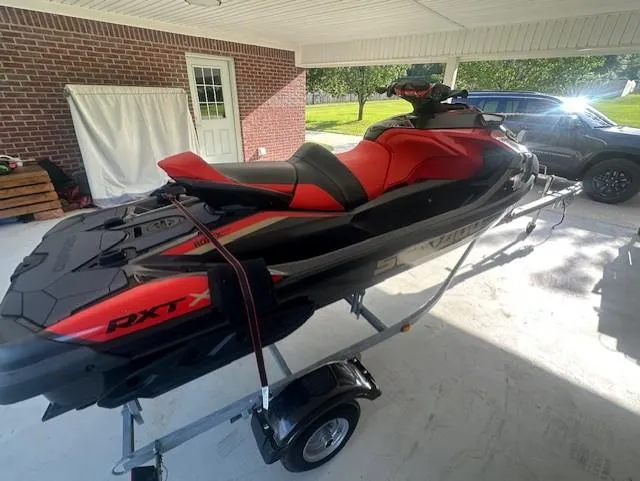 Slide: The Image of 2019 Sea-Doo RXP-X 300 Rotax 1630 ACE jet ski on trailer under a carport. - 3