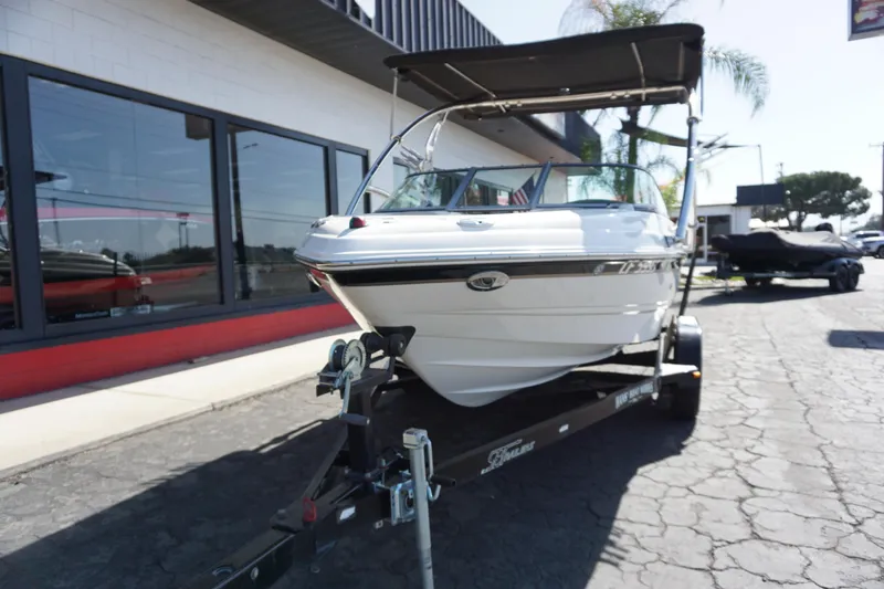 Slide: The Image of 2006 Chaparral SSi 190 boat on trailer, parked outside a building. - 4