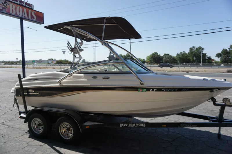 Slide: The Image of 2006 Chaparral SSi 190 boat on trailer with canopy, parked outdoors. - 5