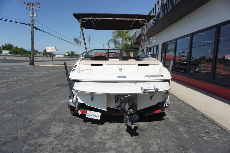 Slide: The Image of 2006 Chaparral SSi 190 boat, rear view, parked on pavement near a building. - 9