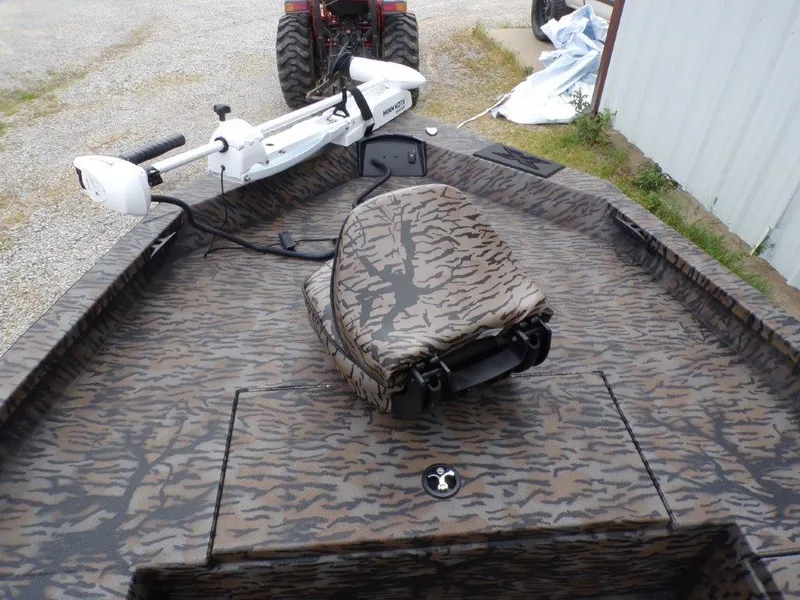 Slide: The Image of 2025 Xpress H20BAY boat with camouflage seating and trolling motor. - 13