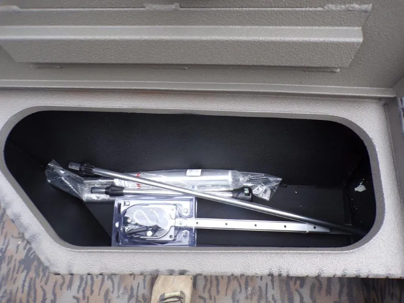 Slide: The Image of Storage compartment of 2025 Xpress H20BAY boat with accessories inside. - 16