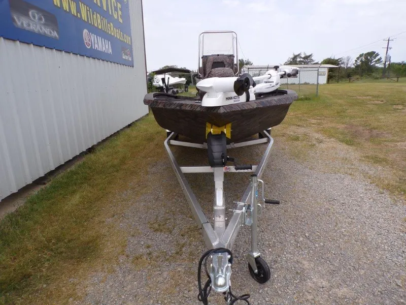 Slide: The Image of 2025 Xpress H20BAY boat on trailer, parked outdoors near a building. - 18