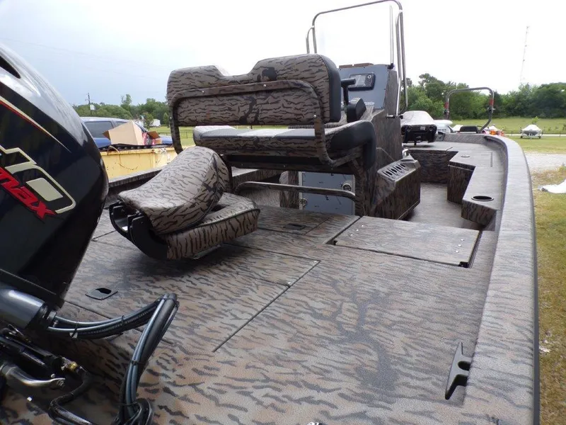 Slide: The Image of 2025 Xpress H20BAY boat interior with camo seats and powerful outboard motor. - 21