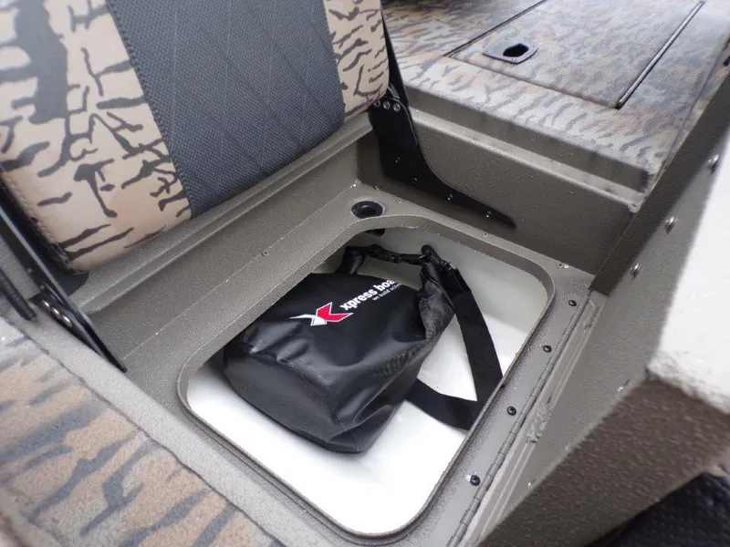 Slide: The Image of 2025 Xpress H20BAY boat storage compartment with a black Xpress-branded bag inside. - 4