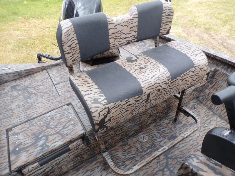 Slide: The Image of 2025 Xpress H20BAY boat interior with camouflage seating and deck design. - 6