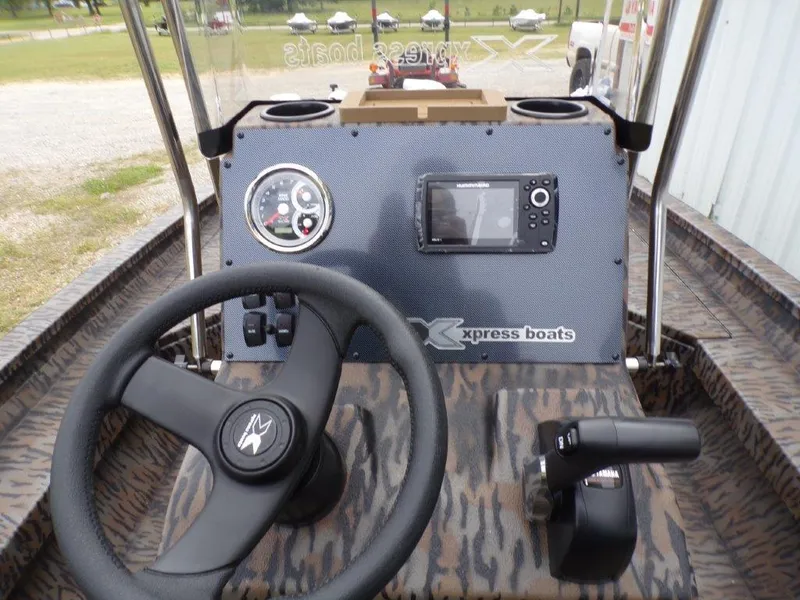 Slide: The Image of 2025 Xpress H20BAY boat dashboard with steering wheel and control panel. - 7